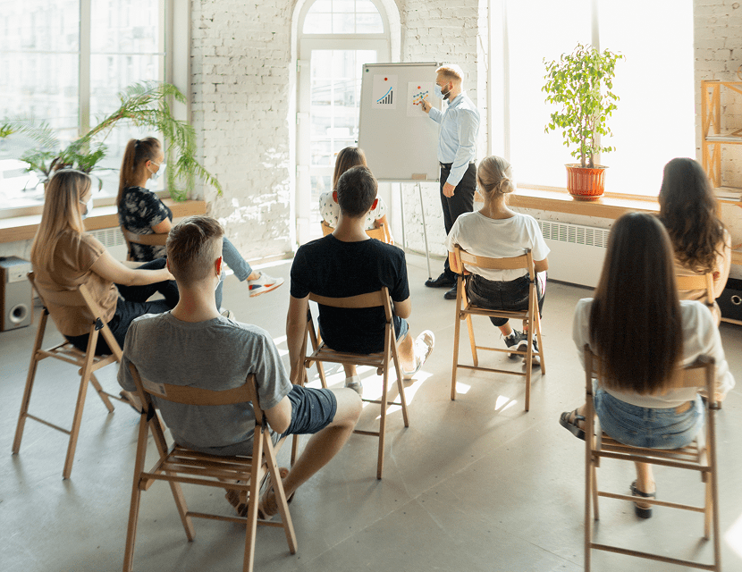 A group attending a presentation in a bright, modern room.