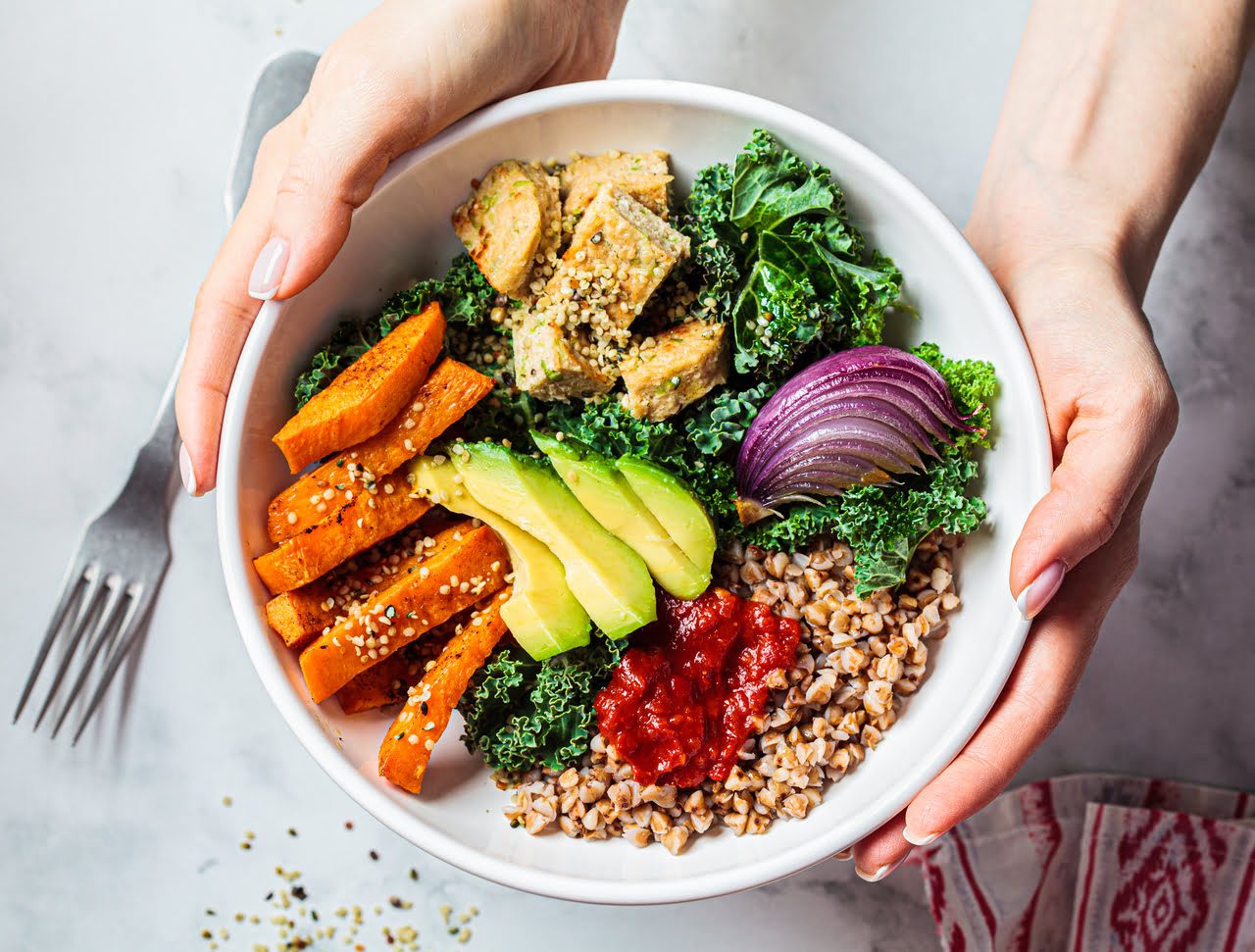 Healthy salad bowl with vegetables and grains.