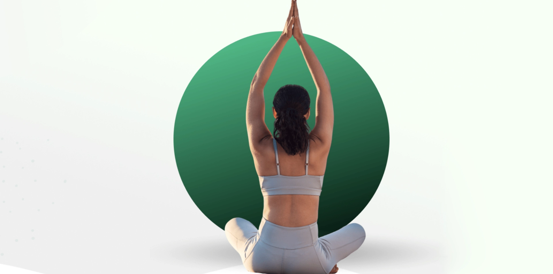 Woman practicing yoga in a seated pose with hands raised.
