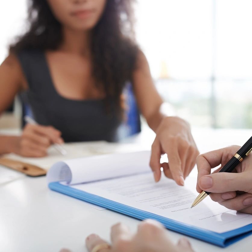 Two people reviewing documents together at a table.